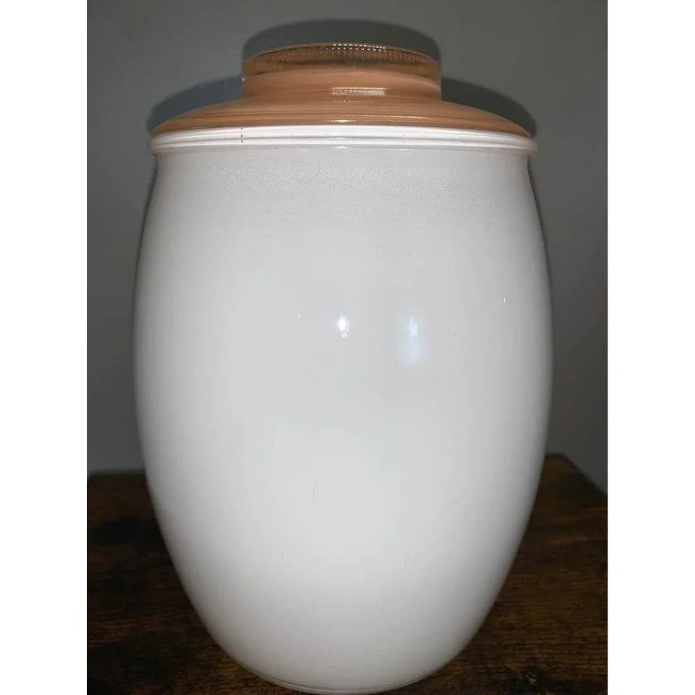 Vintage Bartlett Collins milk glass cookie jar featuring gingerbread man design